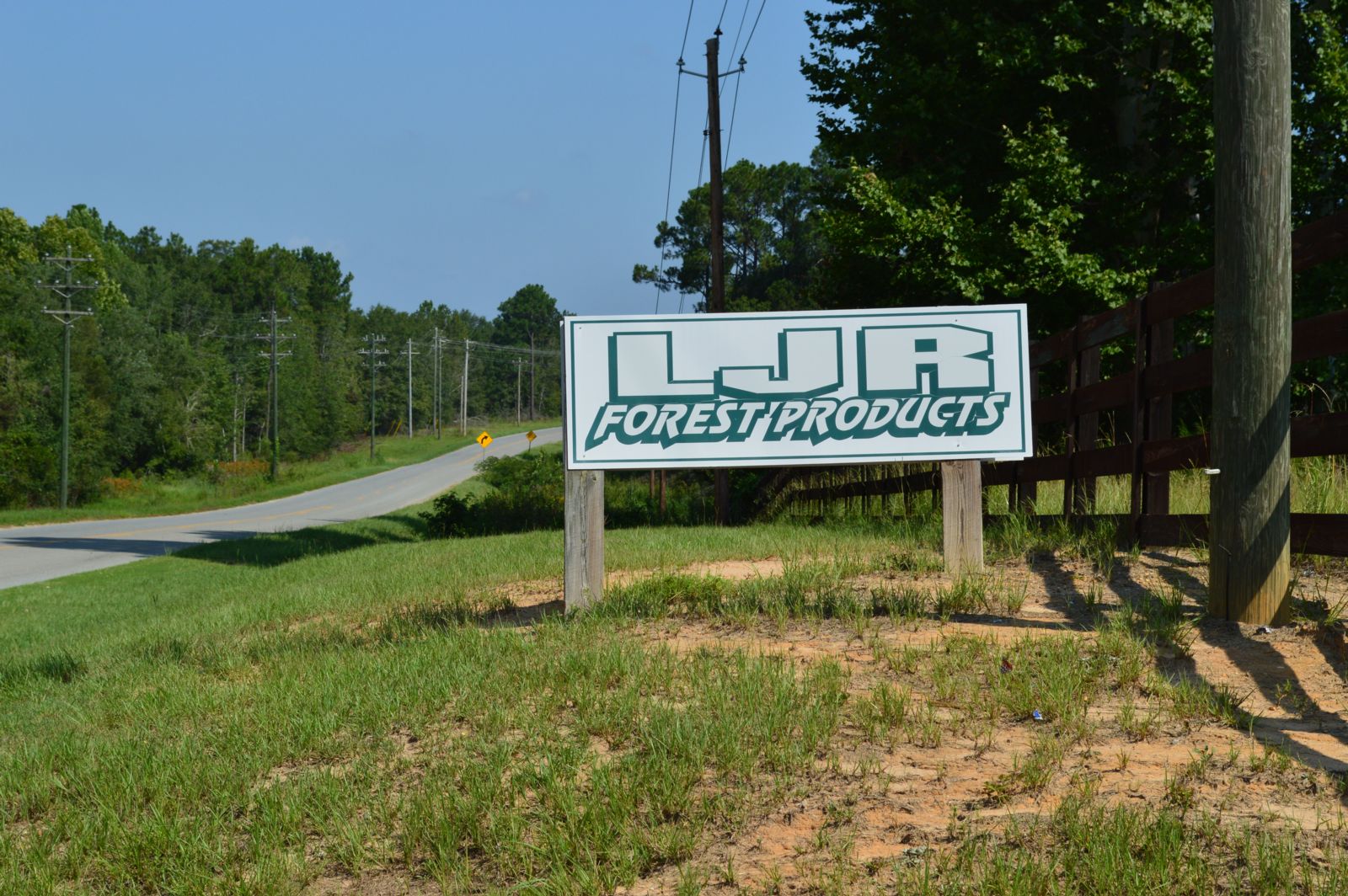 a photo of the LJR forest products sign beside a road
